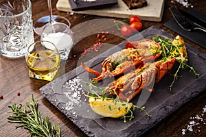 Lobster with flavored butter. Herb butter, lemon. Delicious healthy traditional food closeup served for lunch in modern