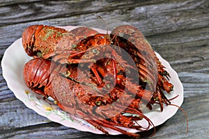 Lobster meal cooked and served, Lobsters are a family Nephropidae, Homaridae of marine crustaceans, with long bodies and muscular