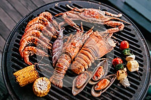 Lobster and mix seafood barbecue cokking on grill