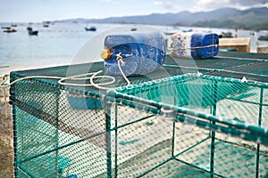 Lobster netting cages on sand beach in Vietnam