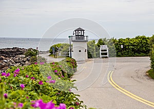 Lobster point lighthouse along the rocky coast of Maine on the Marginal Way path in Ogunquit