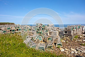 Lobster pots piled on a beach in newfoundland