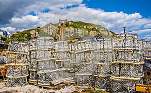 Lobster pots piled high on Hastings Beach beneath the east cliff and funicular railway