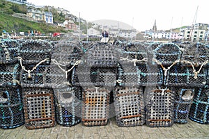 Lobster pots on quay at fishing harbour