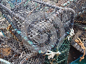 lobster pots used in fishing for crustaceans stacked together in scarborough harbour
