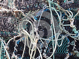 lobster pots used in traditional fishing for crustaceans stacked together in scarborough harbour