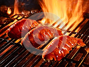 Lobster tails cooking on grill