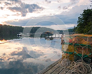 Lobster traps on the dock overlooking bay at dawn Maine summer