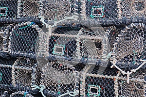 Lobster traps stacked on a Devon quayside UK