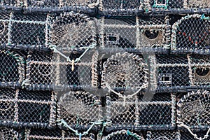 Lobster traps stacked on a quayside UK