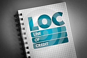LOC - Line of Credit acronym on notepad, business concept background