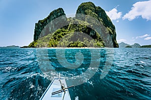 Local banca boat approaching amazing tropical island tour trip to the protected famous archipelago Bacuit El Nido