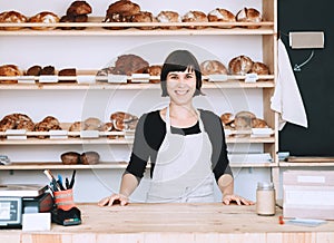 Local business owner or bakery worker behind the counter photo