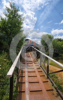 Local Class 450 train crossing bridge over River Wey, Surrey.