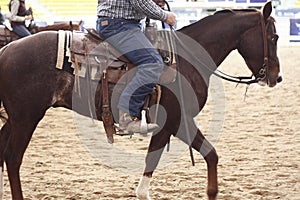 local farmers riding their quaterhorses, competing at a cutting horse, futurity event