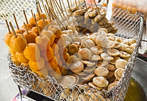 Local Filipino street food with bamboo skewers - Kwek Kwek Quail Eggs, Fishballs, Squid balls, and Kikiam