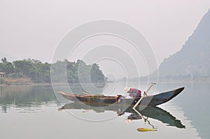 Local fisherman are fishing with his small boat on the Trang An river