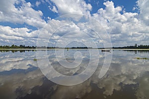 Local fisherman, lake and Neak Pean temple, Angkor, Cambodia