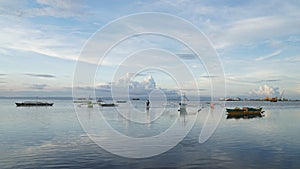 Local fishermen with fishing boat at the port of Tubigon on the Philippines island of Bohol, Southeast Asia.