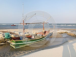 A local fishing boat moored on the beach of Thailand.