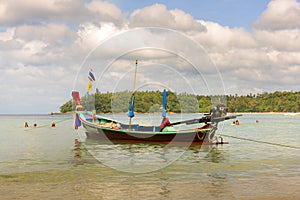 The local fishing boat on the sea and misty cloudy sky background.