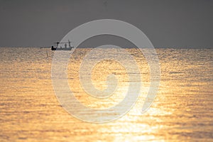 Local fishing boat on the sea with sunrise scene.