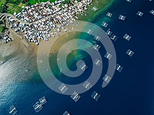 Fishing village and fishing boats in ocean on Sumbawa island. Scenic aerial view