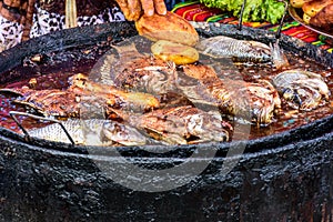 Frying fish on streetside stall, Santiago Sacatepequez, Guatemala photo