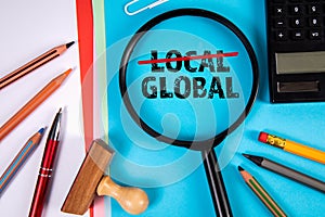 Local and Global concept. Magnifying glass and text on a blue background