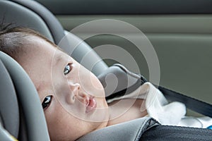 Local lifestyle Asian Chinese baby boy on child safety car seat
