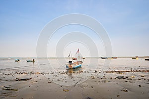 The local long-tailed boats of Thai fishermen are moored on the coast