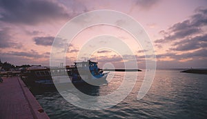 Local Maldivian Boats near the Sandy Beach during the Sunset Time