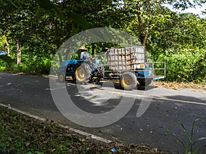 Local man drives farm tractor truck on road