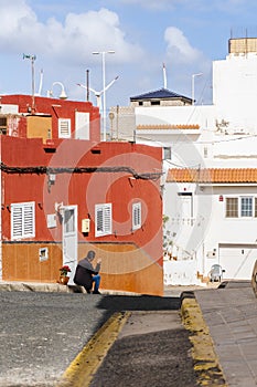 A local man smoking a cigarette sitting in front of his house in the street of Pozo Izquierdo, Spain photo