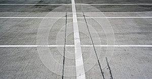 Local parking lot marking of white colour on grey asphalt