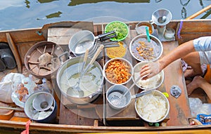 Local people sell fruits, food and souvenirs on boats at Damnoen Saduak Floating Market in Ratchaburi District, Thailand. Famous