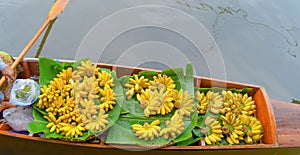 Local people sell fruits, food and souvenirs on boats at Damnoen Saduak Floating Market in Ratchaburi District, Thailand. Famous