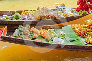 Local people sell fruits, food and souvenirs on boats at Damnoen Saduak Floating Market in Ratchaburi District, Thailand. Famous