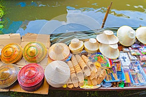 Local people sell fruits, food and souvenirs on boats at Damnoen Saduak Floating Market in Ratchaburi District, Thailand. Famous