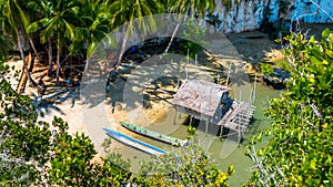 Local people tap new location, Bamboo Hut and Boats on Beach in low Tide, Kabui Bay near Waigeo. West Papuan, Raja Ampat photo