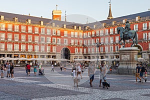 Local people and tourists at the Plaza Mayor (Town square) in the heart of Madrid, Spain.
