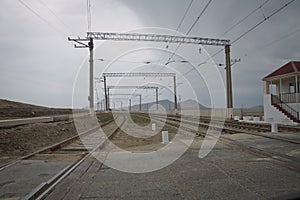 Railway tracks turn to the left. Rails for the train, laid on a hill above the city, smoothly turn left. Technological photo