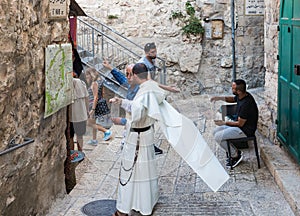 A local resident shows a monk on a map how to get there in the Old City in Jerusalem, Israel
