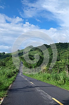 Local Road, Green hill and blue sky view