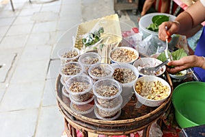 Local seller make Thai Fresh Leaf Wrapped Bite Size Appetizer, Miang Kham at bangrak, Bangkok, Thailand