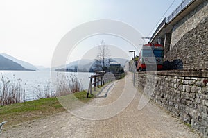 Local smiling train on the shore of Lago di Lugano, Switzerland photo