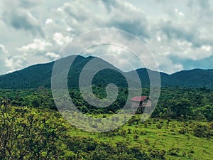 Local stilt hut with cloudy sky in tropical landscape