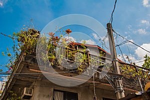 Local street with houses in the Philippines capital Manila.Balcony with flowers