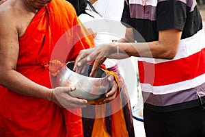 Local thai people join rite ritual Tak Bat Devo Buddhism festival and give food offerings to Buddhist monks in Tak Bat Thewo