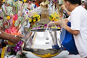 Local thai people join rite ritual Tak Bat Devo Buddhism festival and give food offerings to Buddhist monks in Tak Bat Thewo